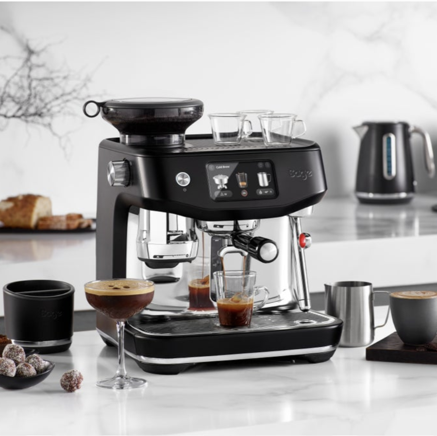 Sage coffee machine on a kitchen counter with coffee being brewed.