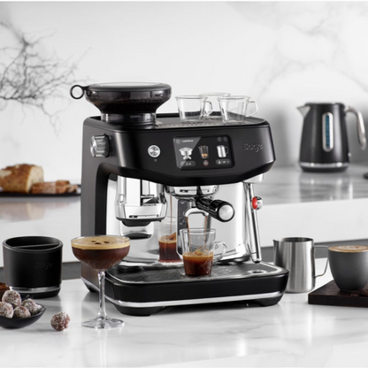 Sage coffee machine on a kitchen counter with coffee being brewed.