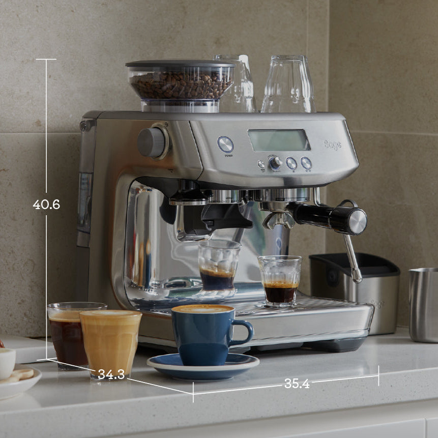 Espresso machine on a kitchen counter with coffee cups and dimensions displayed
